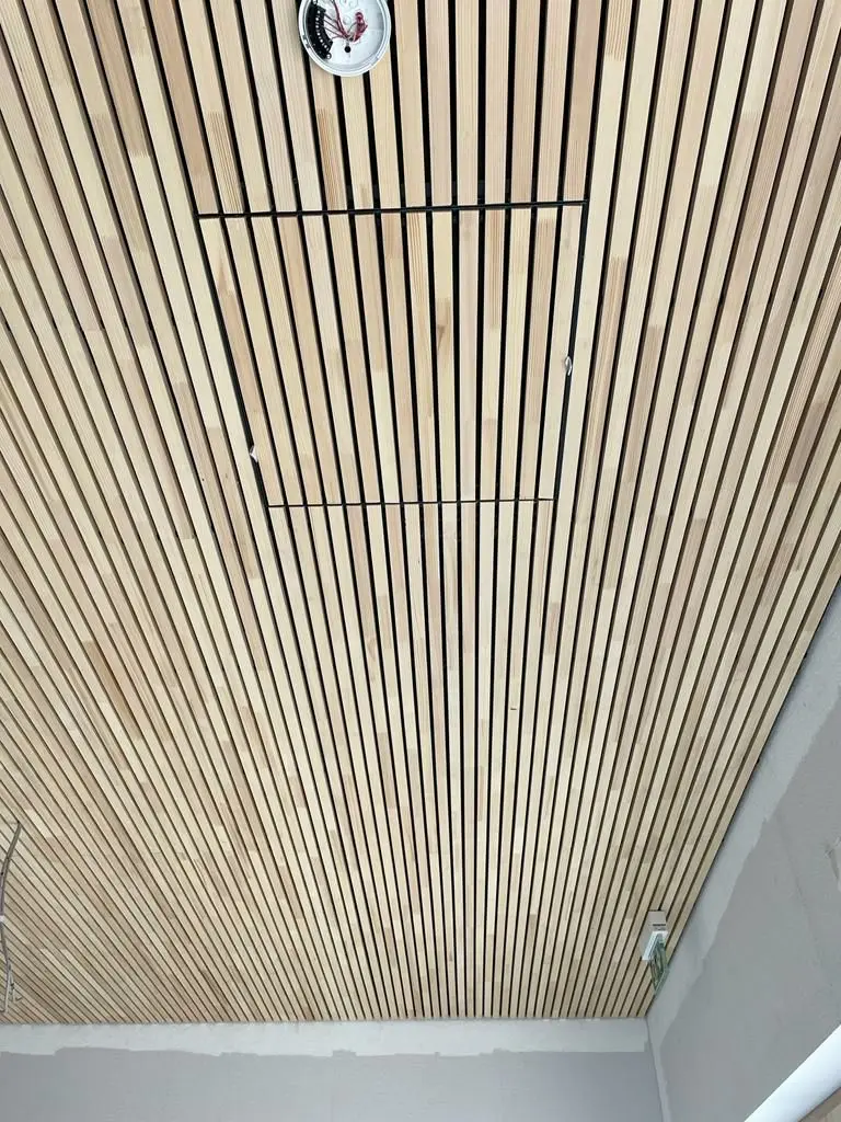 Präzise ausgeführte Holzvertäfelung an einer Decke